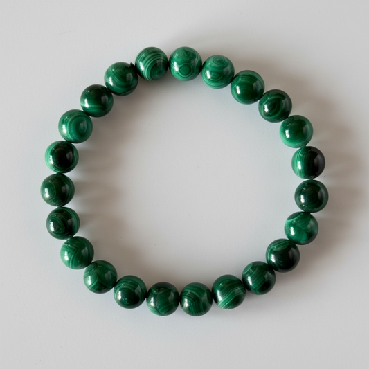 High grade natural Malachite bracelet with 7 mm beads. A protective, grounding crystal known for strength and emotional transformation.