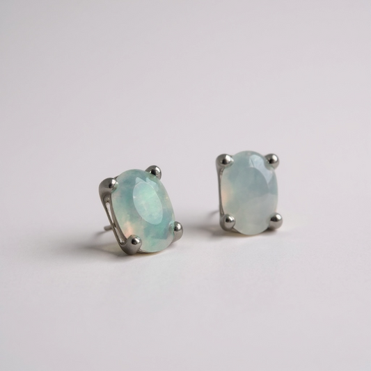 Small sterling silver opal stud earrings with natural shimmer. 5 x 3 mm oval stones; two pairs available.