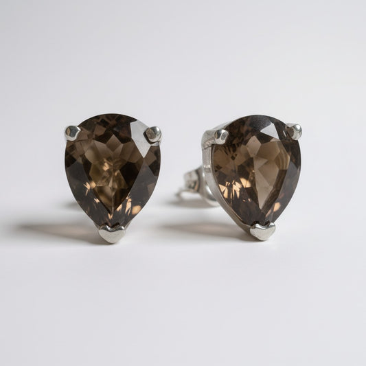 Faceted smoky quartz teardrop studs set in sterling silver. Warm, grounding, and easy for everyday wear with a soft earthy glow.